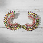 Colorful rainbow crystal oversized statement earrings featuring pink, iridescent and gold rhinestones styled for luxury fashion.