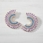 Lavender and clear crystal oversized statement earrings with gold finish, elegant bridal and evening jewelry worn by model.