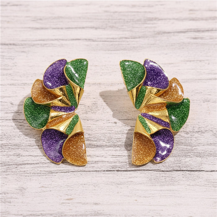 Purple, green, and gold geometric ruffle statement stud earrings with glitter enamel finish displayed on a white wooden background.