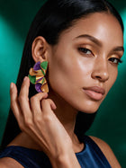 Close-up side profile showing lightweight purple, green, and gold sculptural ruffle earrings with bold geometric design and luxurious gold detailing.