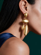 Close-up portrait showcasing lightweight gold waterdrop drop earrings with elongated sculptural silhouette and elegant movement.