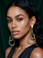 Two-tone gold and silver African-inspired geometric drop earrings featuring elegant openwork loops and lightweight statement styling.
