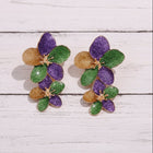 Purple, green, and gold floral statement earrings with glitter enamel petals and lightweight geometric design on a white background.