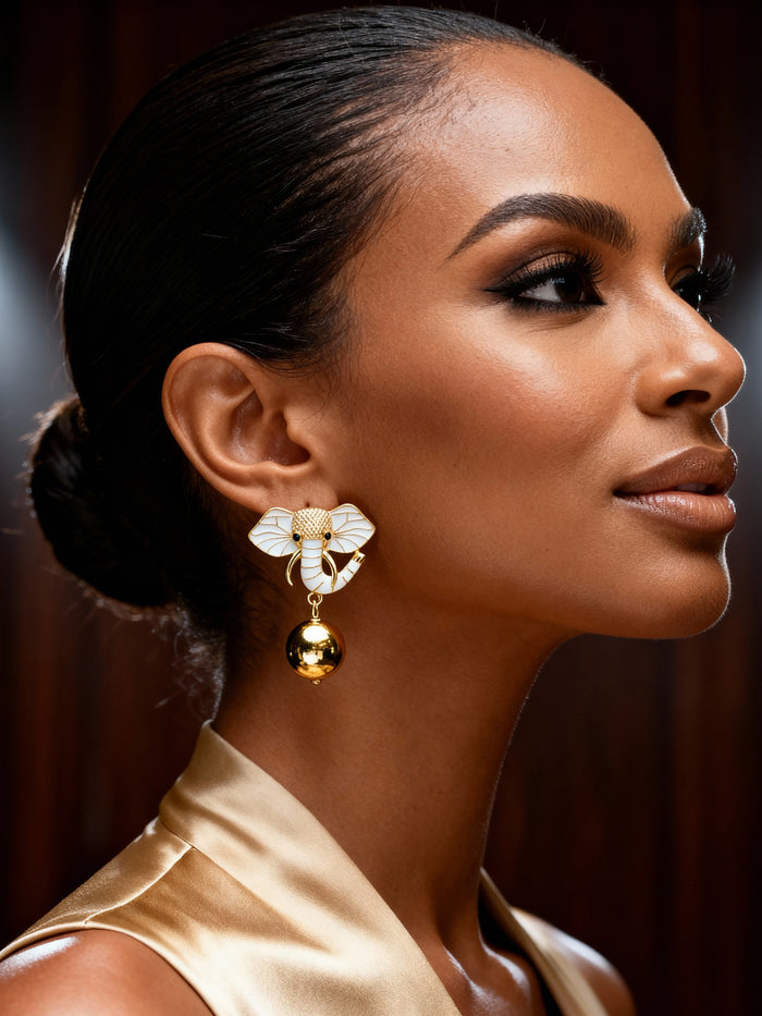 Model wearing gold elephant stud earrings paired with layered gold necklaces for an elegant everyday look.