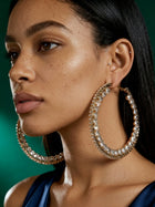 Luxury oversized rhinestone hoop earrings worn by model, elegant bridal jewelry with sparkling crystal accents and timeless gold finish.