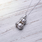18K gold plated pearl peanut pendant necklace displayed on a delicate gold chain with pendant and chain measurements shown on a white wooden background